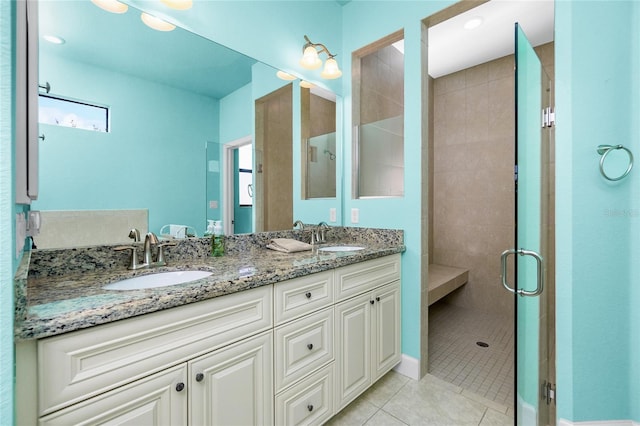 bathroom featuring tile patterned flooring, vanity, and a shower with shower door