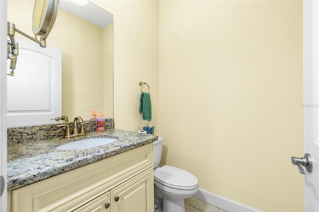 bathroom with tile patterned floors, vanity, and toilet