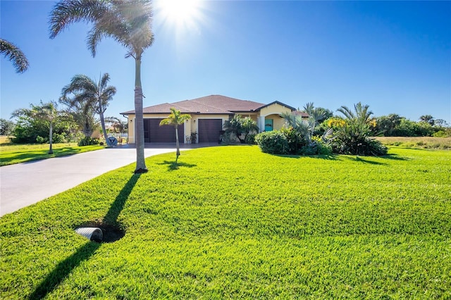 view of front of property with a front yard and a garage