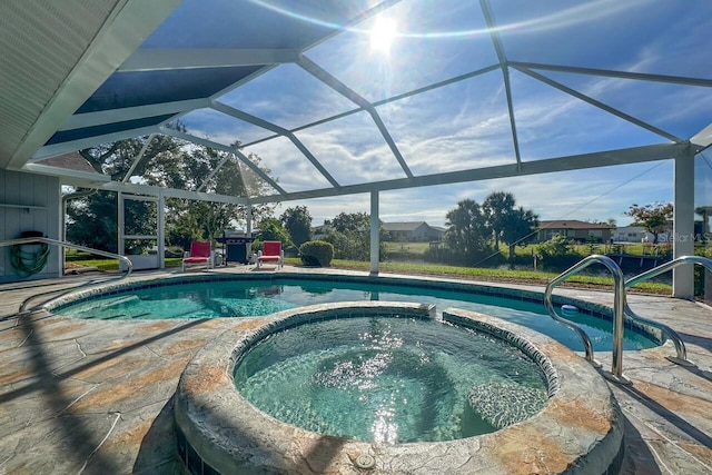 view of swimming pool featuring a patio area, a lanai, and an in ground hot tub