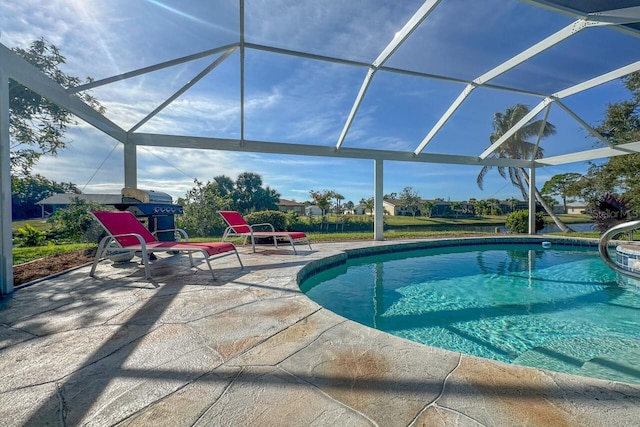 view of swimming pool with glass enclosure and a patio area