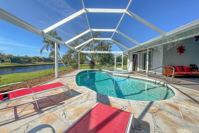 view of swimming pool with a lanai, a patio area, and a water view