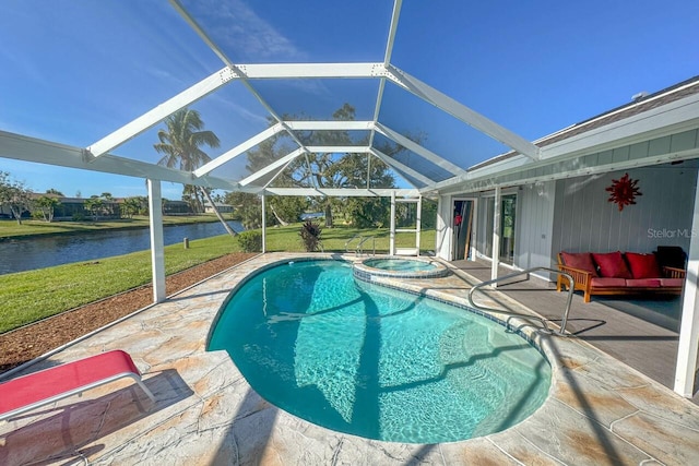 view of swimming pool with an in ground hot tub, a patio, a water view, glass enclosure, and a yard