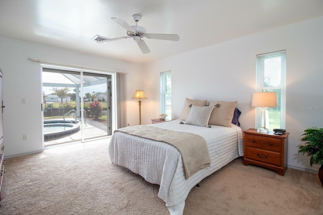 carpeted bedroom with ceiling fan, access to exterior, and multiple windows