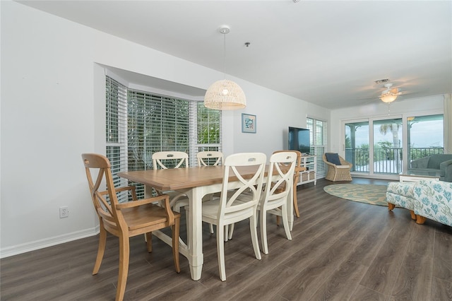 dining room with ceiling fan and dark hardwood / wood-style flooring