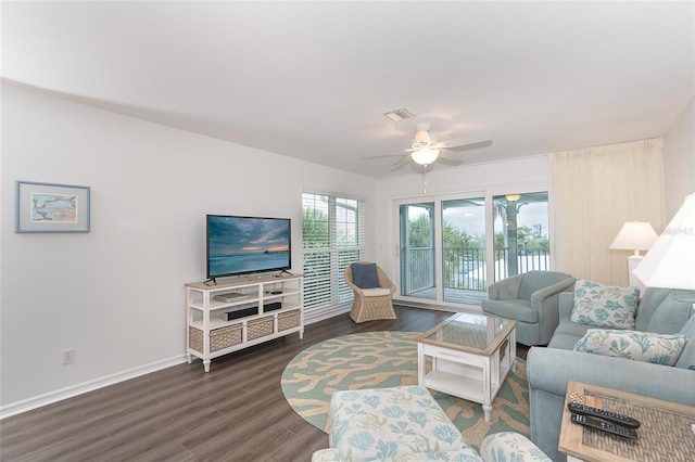 living room with dark hardwood / wood-style flooring and ceiling fan