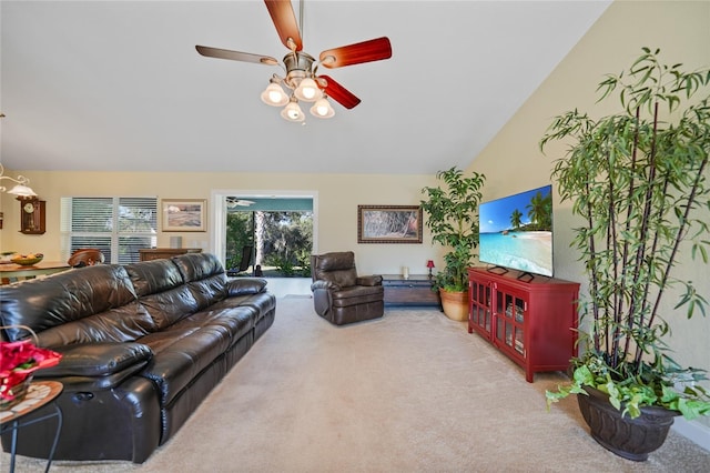 carpeted living room with ceiling fan and lofted ceiling