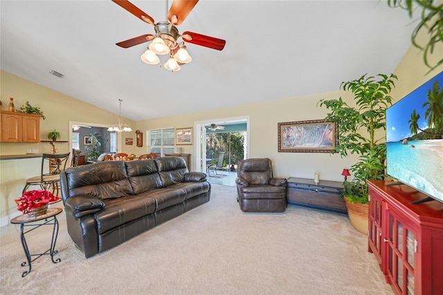 carpeted living room featuring ceiling fan with notable chandelier and lofted ceiling