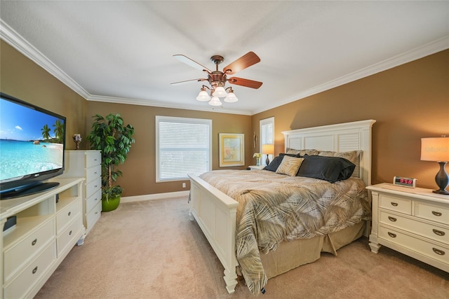 carpeted bedroom featuring ceiling fan and crown molding