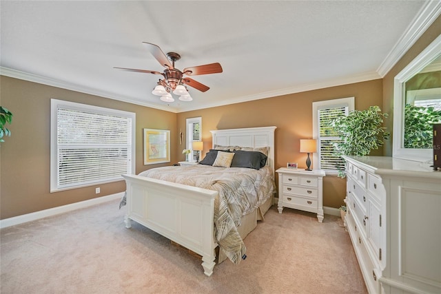 carpeted bedroom with ceiling fan and ornamental molding