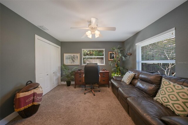 carpeted office with ceiling fan