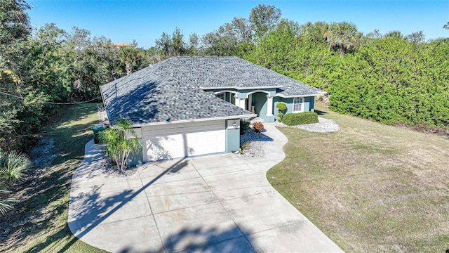 view of front of property featuring a garage and a front lawn