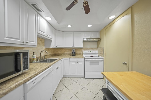 kitchen with white appliances, ceiling fan, sink, light tile patterned floors, and white cabinets