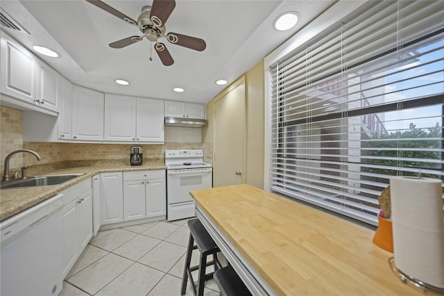 kitchen featuring white cabinetry, light tile patterned flooring, white appliances, and sink