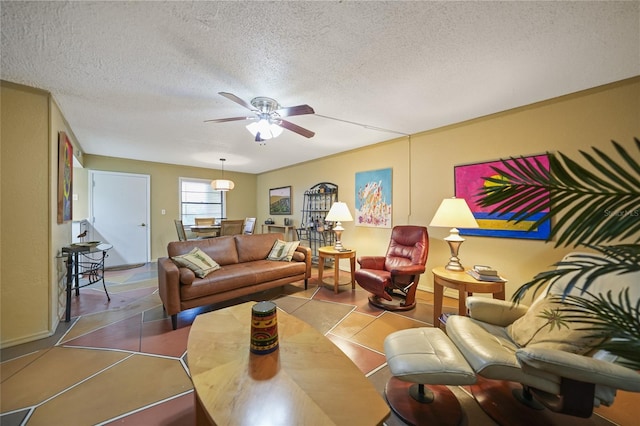 living room with tile patterned floors, ceiling fan, and a textured ceiling