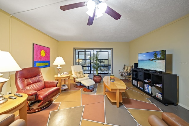 living room featuring a textured ceiling, ceiling fan, and ornamental molding