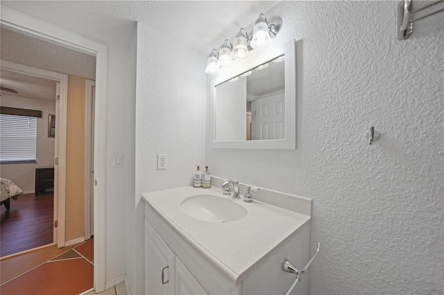 bathroom with vanity, a textured ceiling, and hardwood / wood-style flooring