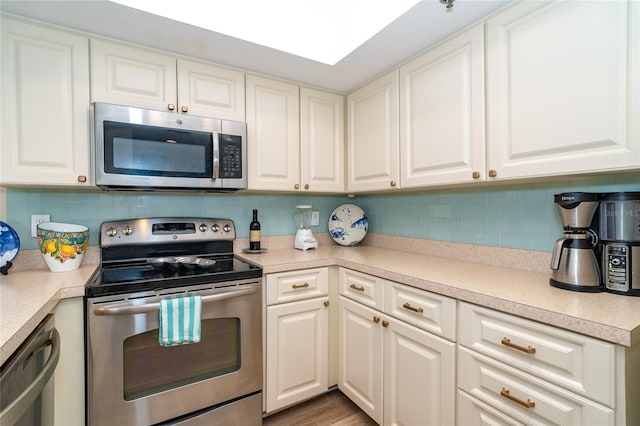 kitchen featuring white cabinets and appliances with stainless steel finishes