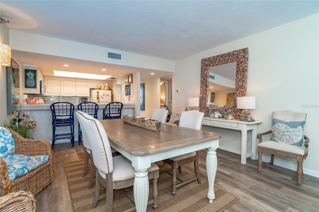 dining space featuring wood-type flooring