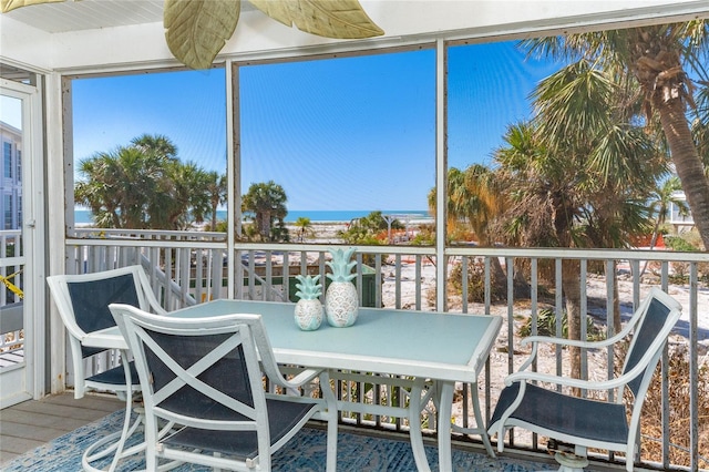 sunroom / solarium with a water view