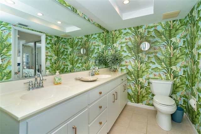 bathroom featuring tile patterned floors, a skylight, vanity, and toilet