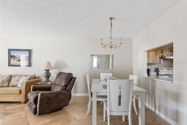 tiled dining room with a textured ceiling and a notable chandelier