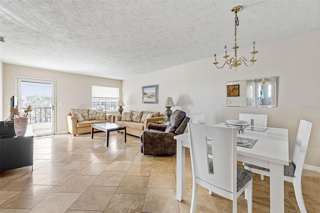 tiled dining area featuring a textured ceiling and an inviting chandelier