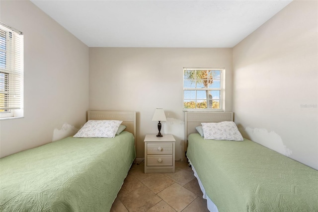 tiled bedroom with multiple windows