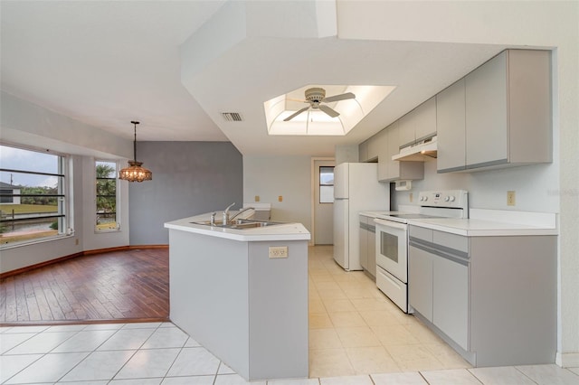 kitchen with sink, white appliances, gray cabinets, and ceiling fan