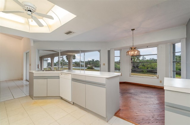 kitchen featuring light tile patterned flooring, sink, white cabinets, ceiling fan, and white dishwasher