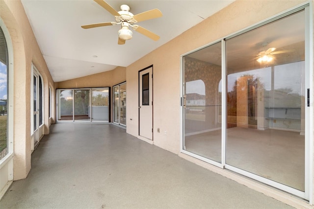 unfurnished sunroom featuring vaulted ceiling and ceiling fan