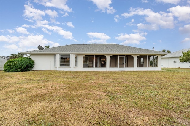 back of house featuring a yard and a sunroom