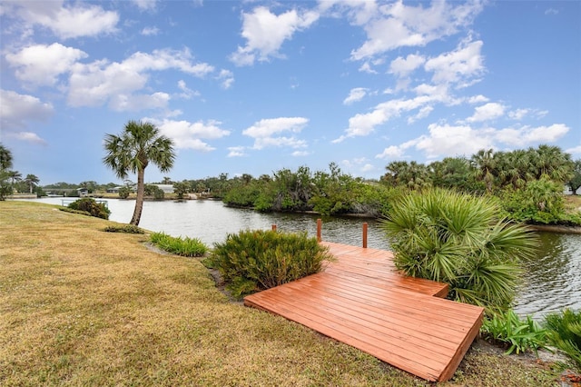 dock area featuring a water view and a yard