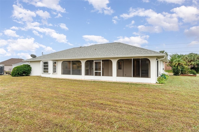 back of house with a sunroom and a yard