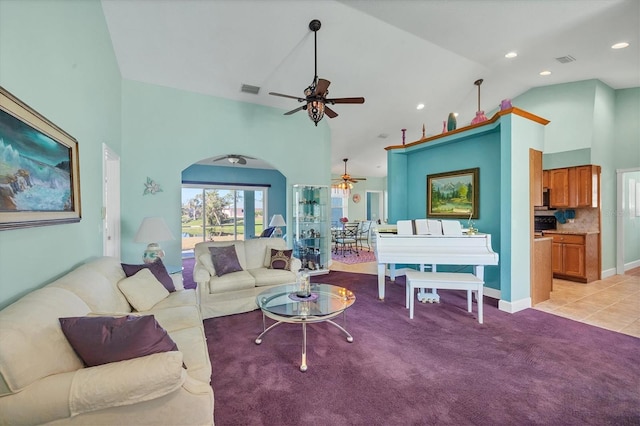 carpeted living room featuring ceiling fan and high vaulted ceiling