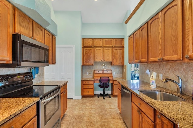 kitchen featuring decorative backsplash, appliances with stainless steel finishes, light stone countertops, and sink