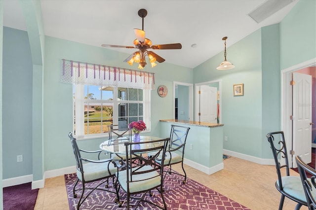 tiled dining room featuring ceiling fan and vaulted ceiling