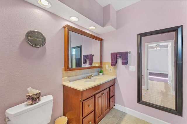 bathroom featuring ceiling fan, tile patterned flooring, vanity, and toilet