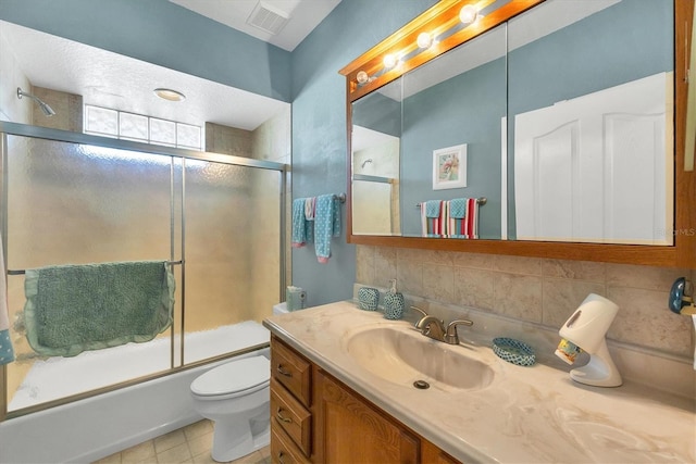 full bathroom featuring shower / bath combination with glass door, decorative backsplash, vanity, and toilet