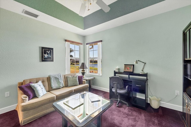 carpeted office space featuring ceiling fan