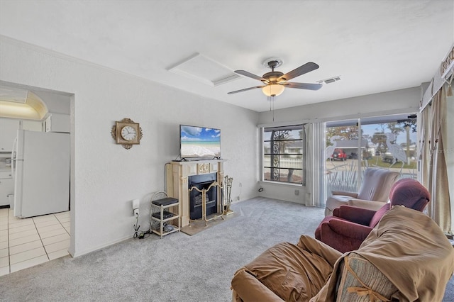 carpeted living room with ceiling fan