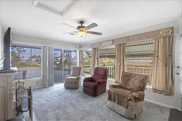 sitting room with ceiling fan, ornamental molding, and carpet floors