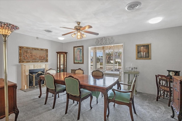 carpeted dining space featuring ceiling fan