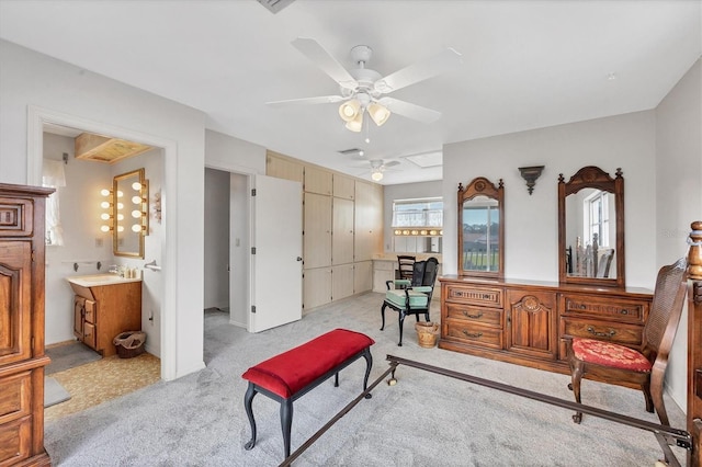 living area featuring sink, light colored carpet, and ceiling fan