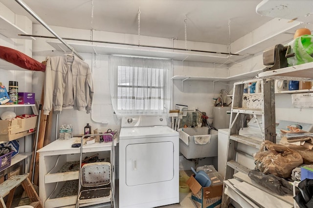 washroom with washer / clothes dryer, sink, and water heater