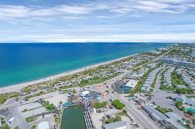 bird's eye view with a water view and a beach view