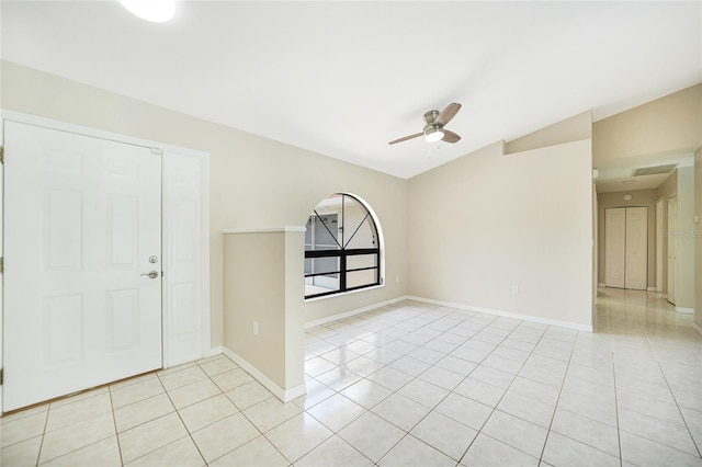 tiled foyer entrance featuring ceiling fan and lofted ceiling