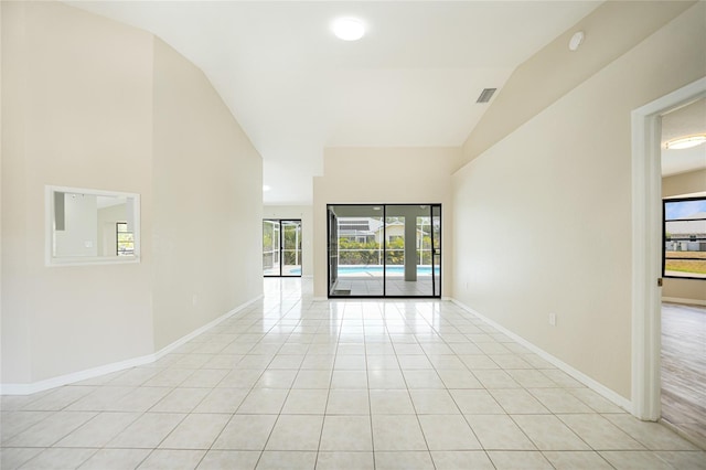 tiled empty room with vaulted ceiling