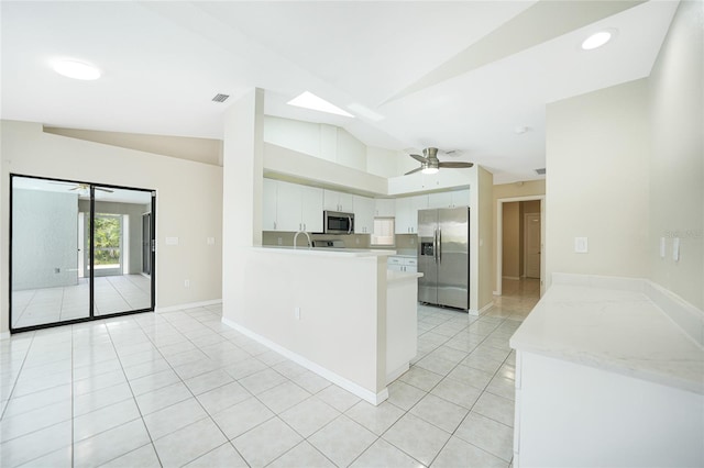 kitchen with white cabinetry, ceiling fan, stainless steel appliances, kitchen peninsula, and vaulted ceiling