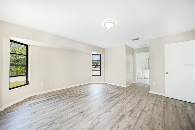 empty room with light hardwood / wood-style flooring